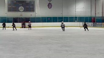 Getting to the loose puck…fighting off defender and going backhand for a goal! Image